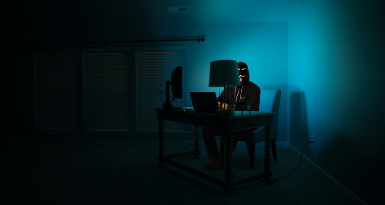 Person working at desk with laptop