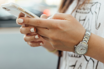 Woman checking smartphone in office setting